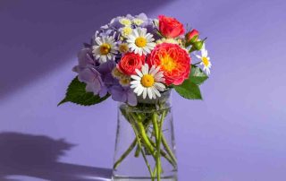 Summer Flower Arrangement of Miniature Roses Daisies and Hydrangea